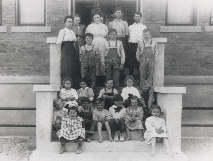 1910 class photo at the Little Red Schoolhouse, capturing a moment in its early years as a cornerstone of education in Scottsdale.